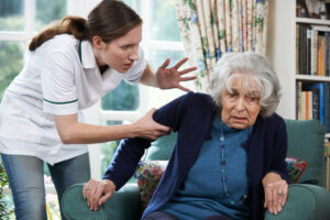 Care Worker Mistreating Senior Woman At Home